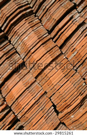 Stock photo of  old red tiles put one on another