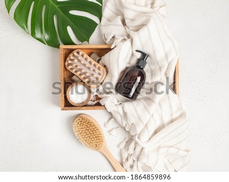 Brown bottle mockup for bathing products in the bathroom, spa shampoo, shower gel, liquid soap on cotton towel and various accessories flat lay. Top view. copy space