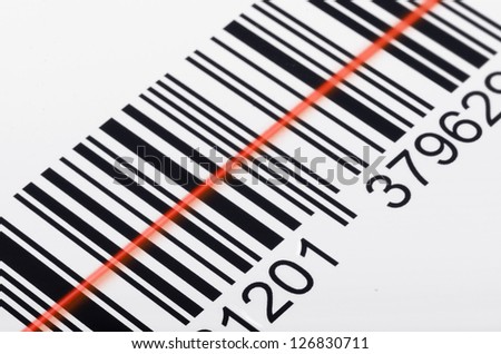Close-up of barcode with laser scanner beam