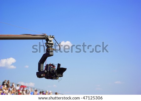 Professional TV camera on the crane on outdoor concerts