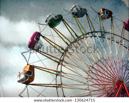 aged vintage photo of carnival ferris wheel with beautiful cloudy sky