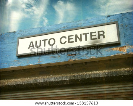 aged and worn vintage photo of auto center sign