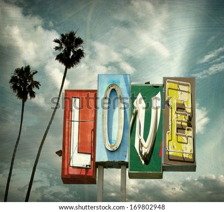 aged and worn vintage photo of  neon love sign with palm trees