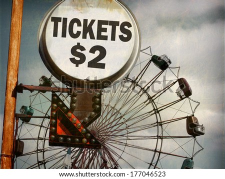 aged and worn vintage photo of  ticket sign at carnival with ferris wheel