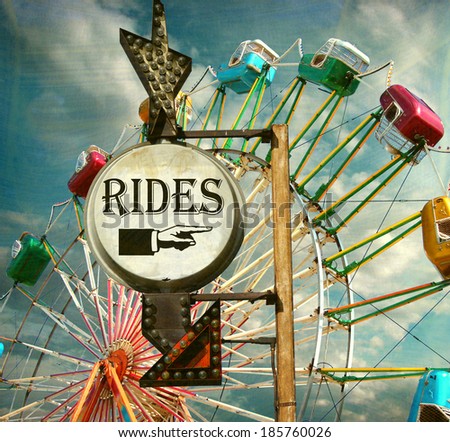 aged and worn vintage photo of rides sign with ferris wheel at carnival