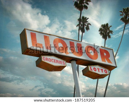 aged and worn vintage photo of  liquor store sign with palm trees