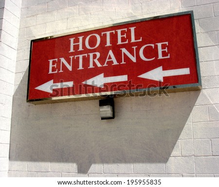 aged and worn vintage photo of  hotel entrance sign with arrows
