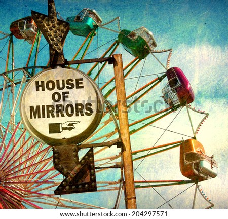 aged and worn vintage photo of house of mirrors sign at carnival