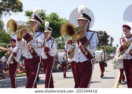 HUNTINGTON BEACH, CA - JULY 4: Marching band playing brass instruments during Huntington Beach July 4th parade