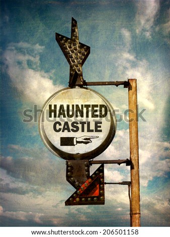 aged and worn vintage photo of haunted castle sign with stormy sky