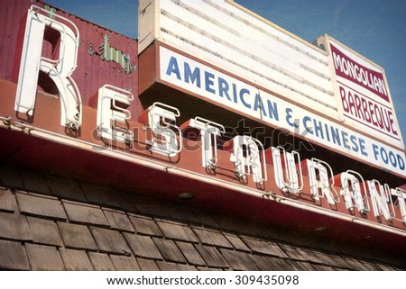 aged and worn vintage photo of old neon restaurant sign