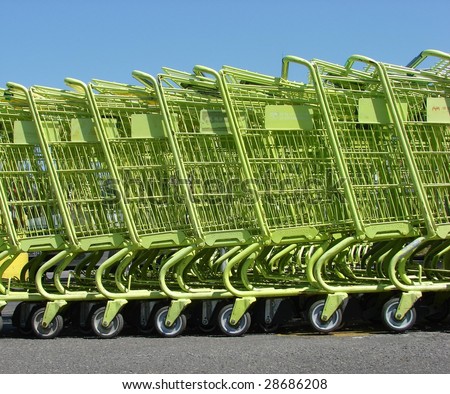 Row of green shopping carts with blue sky