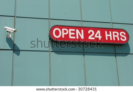 Security Camera and Open 24 Hours Sign