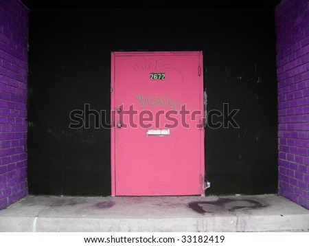 pink  door with graffiti and purple brick