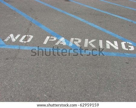 no parking sign on parking lot pavement