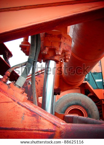 red industrial machinery with steel rod