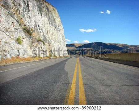 desolate road alongside cliff landscape