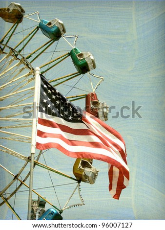 aged and worn vintage photo of american flag with ferris wheel carnival ride in background
