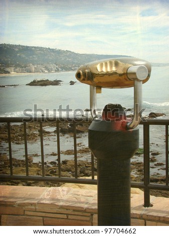 aged and worn vintage photo of   binoculars overlooking beach