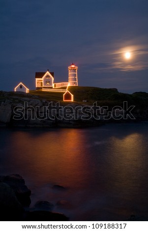Full moon rising over the Nubble lighthouse at Christmas in July