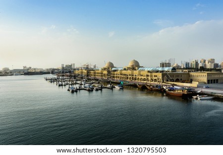 Aerial View of souq al jubail and port of sharjah with boats docked at pier