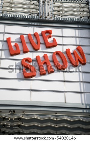 an old retro looking live show sign at a theater