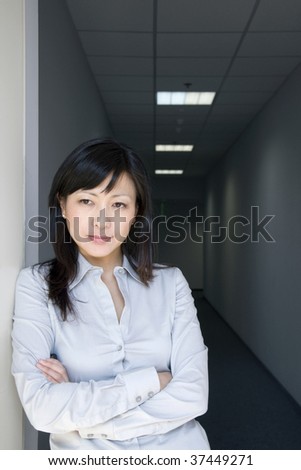 thoughtful businesswoman in a dark office corridor