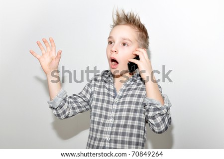 boy (ten years old) with smartphone, scared