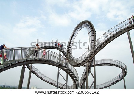 DUISBURG, GERMANY - 25 August 2013 Tiger & Turtle sculpture  Magic Mountain with visitors