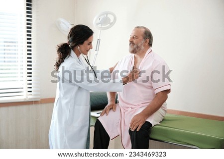 Female doctors in uniform healthy check White male patients in examination coat by stethoscope, and checkups and advise health care diagnosis at clinic hospital, and appointments visit. Foto stock © 