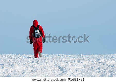 Walk alone: a man in thermo clothes walking away