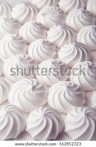 White meringue cake on white background