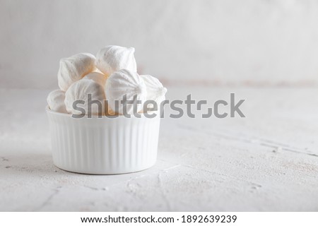 Traditional French dessert Meringue. White sweet meringue prepared from whipped with sugar and baked eggs on concrete background.  Foto d'archivio © 