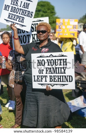 SANFORD, FL-MACRH 26:  A female protester holds a sign in support of Trayvon Martin on March 26, 2012 in Sanford Florida.