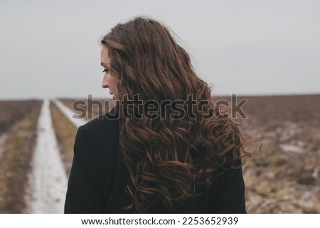 Similar – Image, Stock Photo Lonely woman with long hair looking at a hill