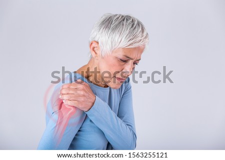 Senior woman with shoulder pain. Elderly woman is enduring awful ache. Shoulder Pain In An Elderly Person. Senior lady with shoulder pain