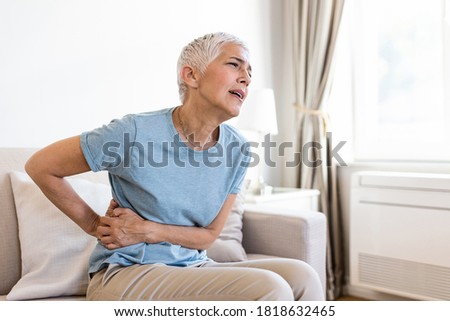Similar – Image, Stock Photo Senior woman feeling pain while consulting doctor on her smart phone