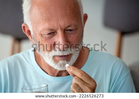 Similar – Image, Stock Photo Senior man taking prescription medicine at home