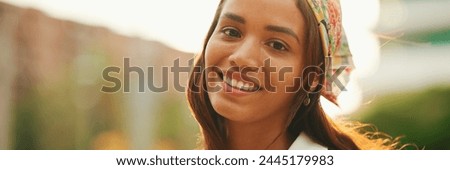 Similar – Image, Stock Photo Close up backlight portrait of a young, freckled woman with wind-blown hair in front of a bush