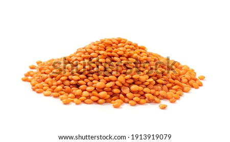 Red lentils pile isolated. Dry orange lentil grains, heap of dal, raw daal, dhal, masoor, Lens culinaris or Lens esculenta on white background