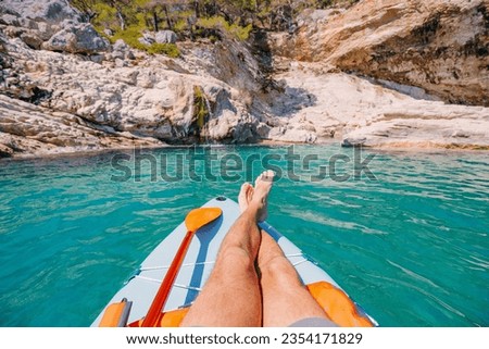 Similar – Image, Stock Photo Person legs on seascape background during sunset