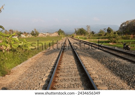 Similar – Image, Stock Photo Railroad tracks on the green bank of the river Main in summer sunshine in the east end of Frankfurt am Main in Hesse, Germany