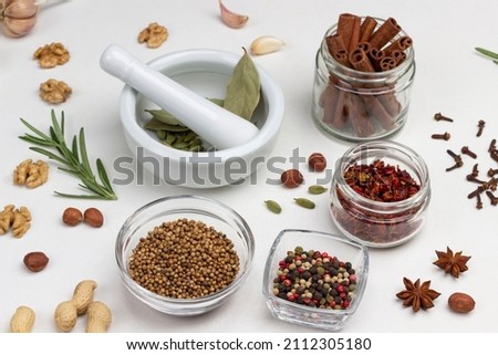 Dry spices in glass jars. Cardamom in mortar and pestle. White background. Top view Stock fotó © 