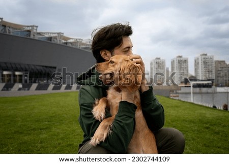 Similar – Image, Stock Photo Man playing with dog on beach
