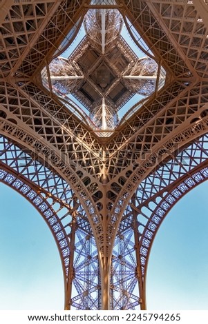 Image, Stock Photo Under the Eiffel Tower .  With light and shadow . Above me the Great Steel Frame . In the background a skyscraper and many trees.