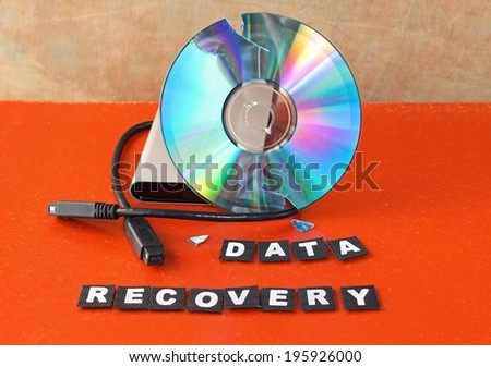 Broken DVD disc with data recovery text