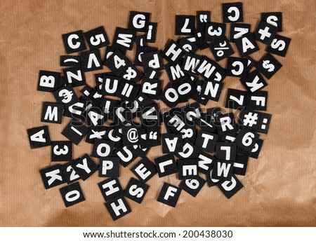 Set of black typography letters pile on brown background