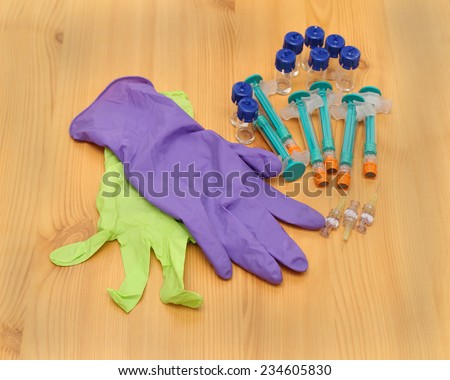 Medicine vials and syringes with surgical gloves