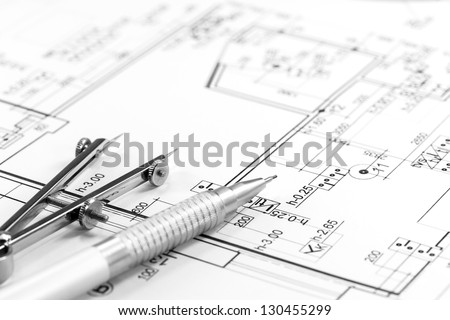 Drawing compass and pencil on house floor plan