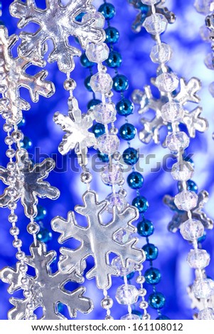 Winter background with glittery silver snowflakes